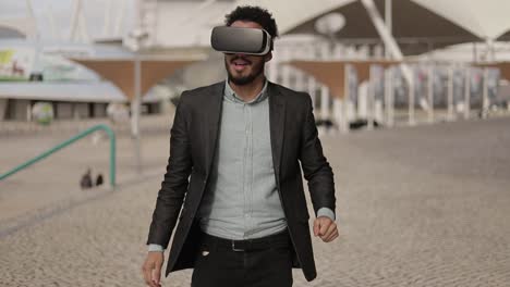 Young-middle-eastern-man-wearing-formal-suit-with-VR-glasses